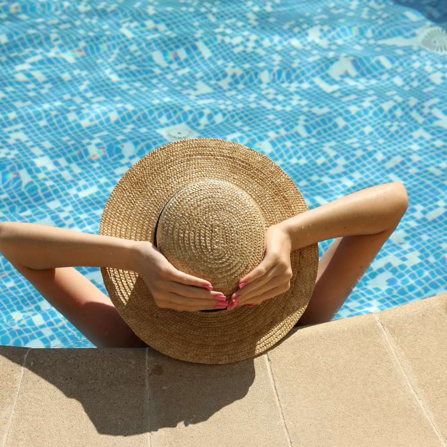 Woman relaxing in a resort-style swimming pool